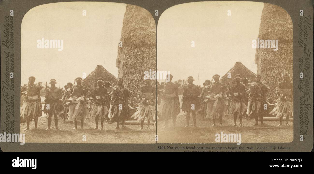 Natives in festal costume ready to begin the 'fan' dance, Fiji Islands. By Underwood & Underwood, publishers, c1905. Stereograph showing men, wearing traditional clothing, lined up for the ceremonial 'meke' fan dance. Stock Photo