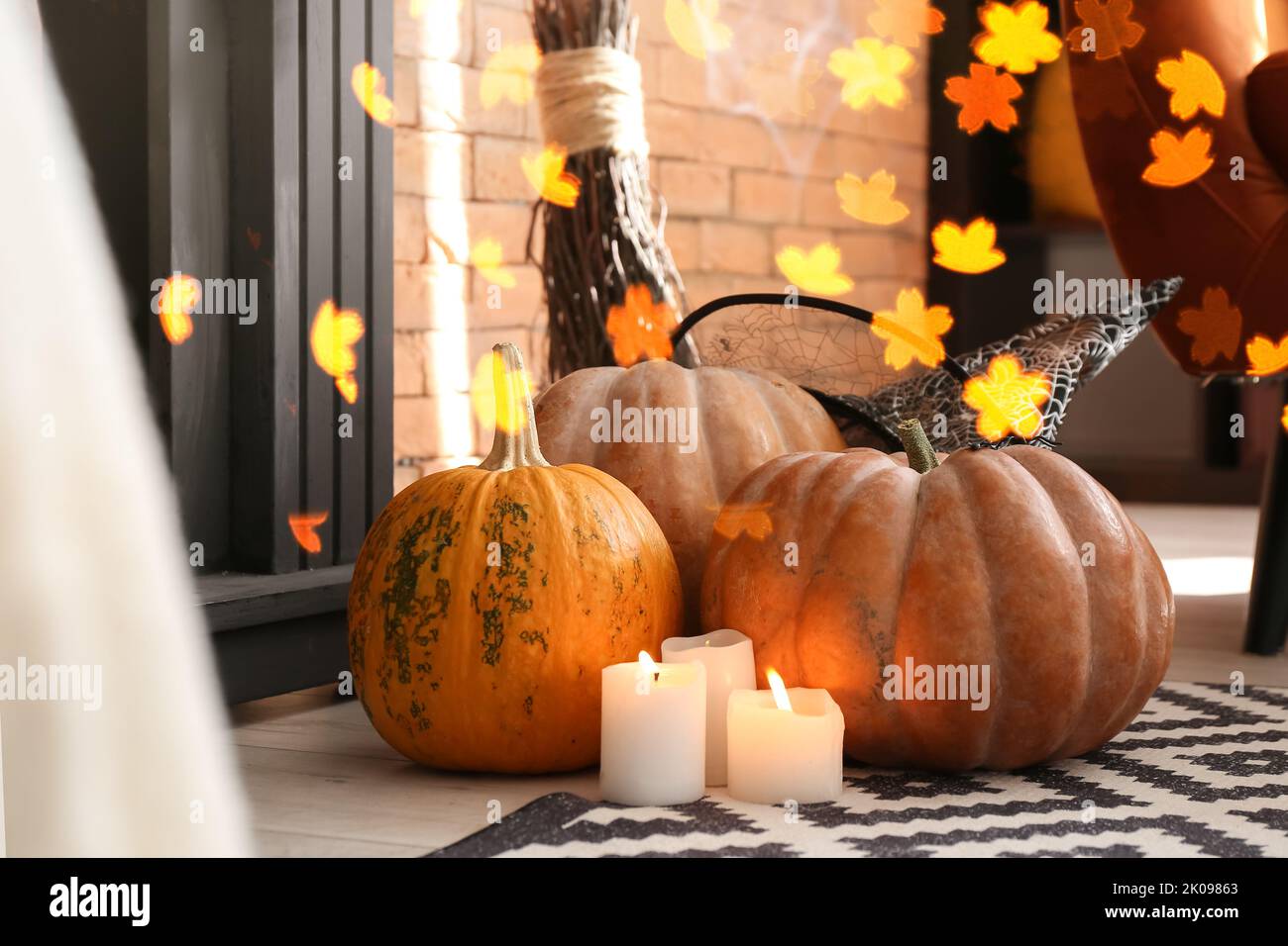 Halloween pumpkins with candles and witch's hat in room Stock Photo - Alamy