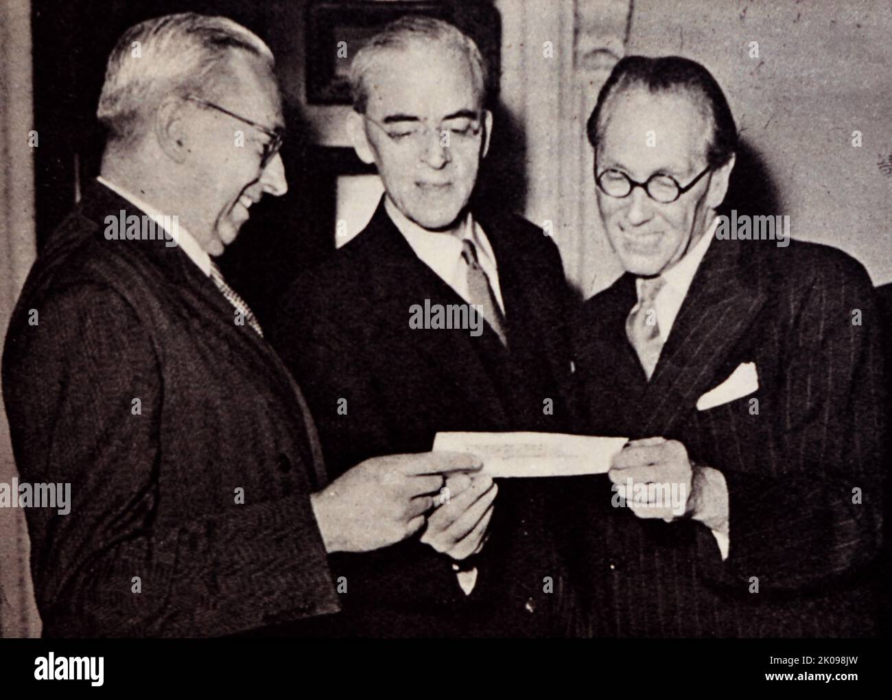 The third gift from Australia in three years. Sir Stafford Cripps receiving a cheque from Mr Mighell. Sir Richard Stafford Cripps CH QC FRS (24 April 1889 - 21 April 1952) was a British Labour Party politician, barrister, and diplomat. Sir Norman Rupert Mighell CMG (12 June 1894 - 13 April 1955) was an Australian ANZAC Officer, Gallipoli survivor, company director, public servant, and diplomat. After his military service, Mighell directed many companies and later served Australia as the Deputy High Commissioner for Australia in London. Stock Photo