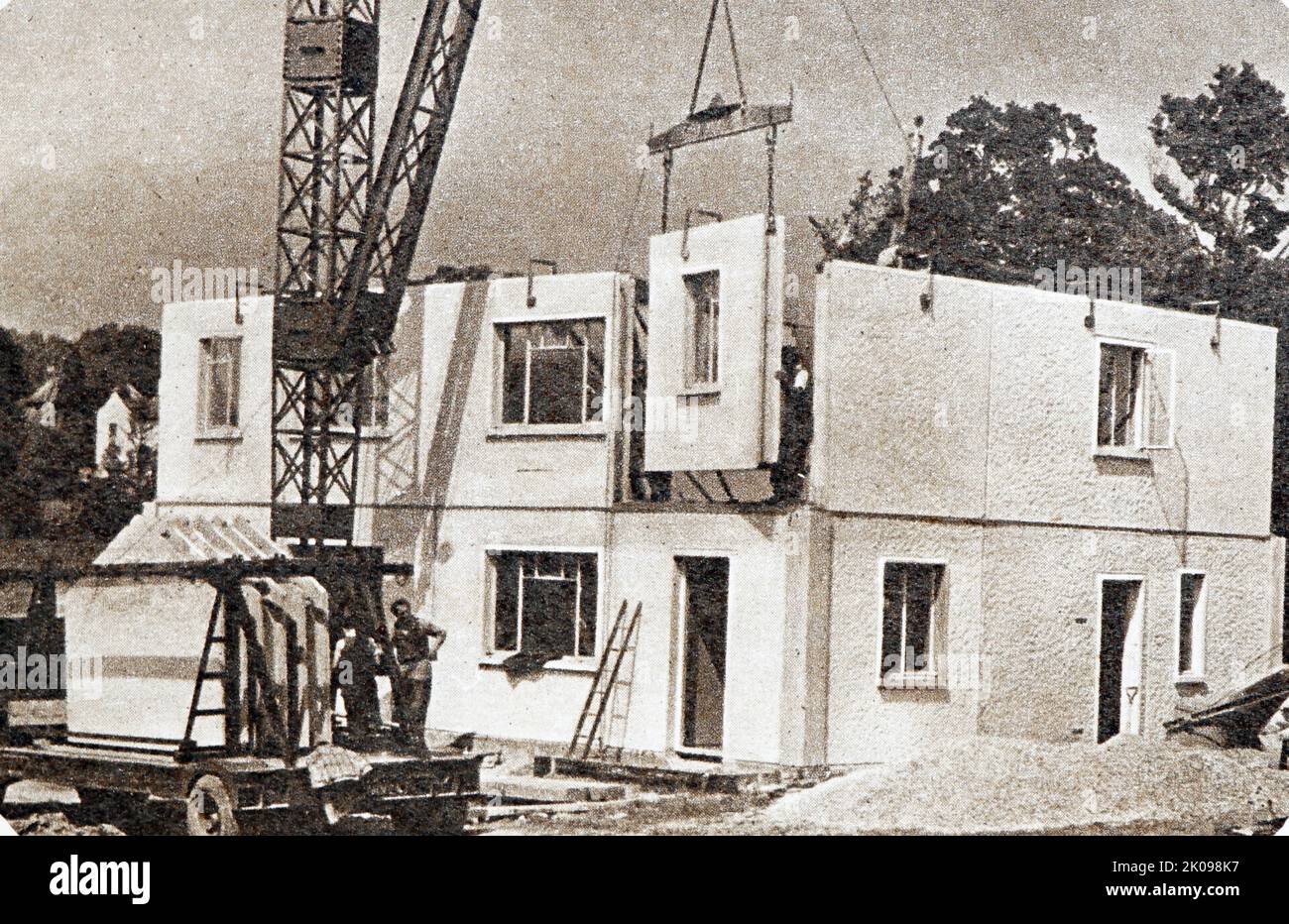 Concrete units being erected for new semi-detached concrete pre-fabricated houses. Prefabs (prefabricated homes) were a major part of the delivery plan to address the United Kingdom's post-Second World War housing shortage. They were envisaged by war-time prime minister Winston Churchill in March 1944, and legally outlined in the Housing (Temporary Accommodation) Act 1944. Stock Photo