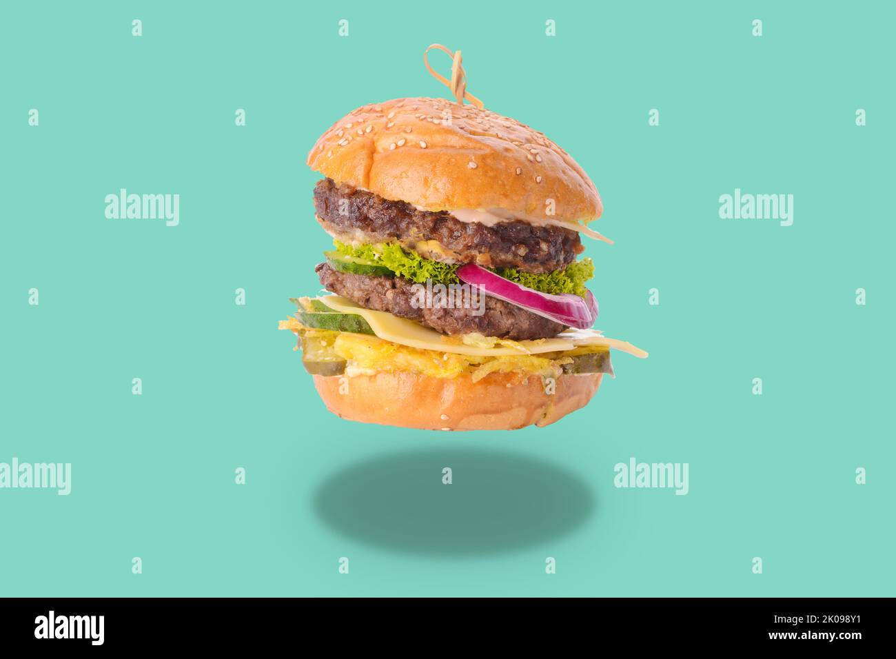 Tasty fresh burger on turquoise background Stock Photo