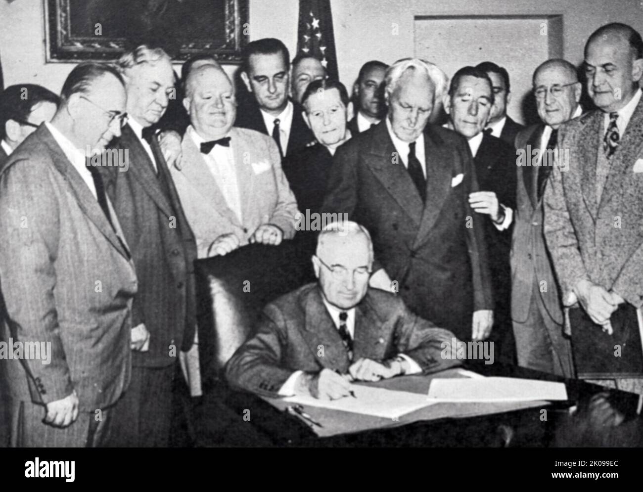 President Truman signs the Mutual Defence Assistance Act of 1949 in the cabinet room of the White House. Harry S. Truman (May 8, 1884 - December 26, 1972) was the 33rd president of the United States, serving from 1945 to 1953. A lifetime member of the Democratic Party, he previously served as the 34th vice president from January to April 1945 under Franklin Roosevelt, and as a United States Senator from Missouri from 1935 to January 1945. Stock Photo