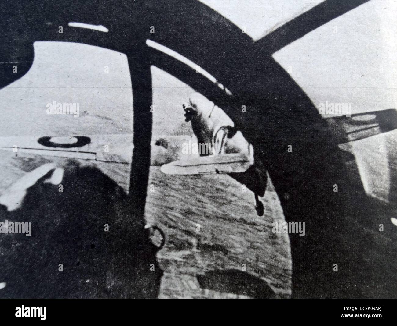 Rear gunner of a Nazi bomber firing on a British Spitfire during World War II, by Heinrich Hoffmann. Heinrich Hoffmann (12 September 1885 - 15 December 1957) was Adolf Hitler's official photographer, and a Nazi politician and publisher, who was a member of Hitler's intimate circle. Stock Photo