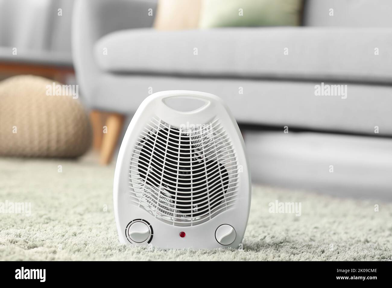 Electric fan heater on carpet in living room Stock Photo Alamy