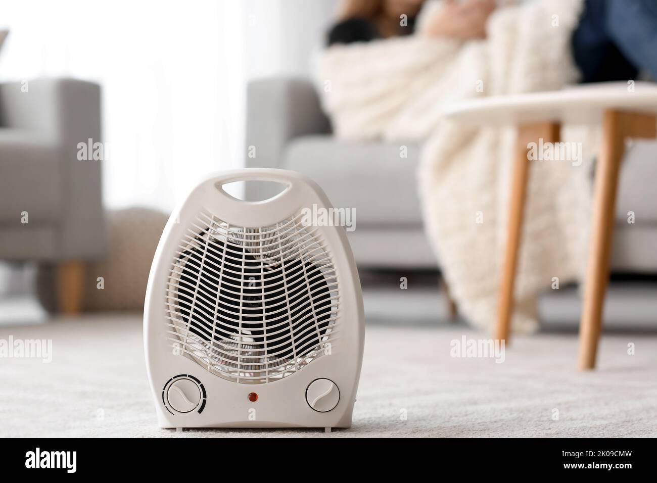 Electric fan heater on carpet in living room Stock Photo Alamy