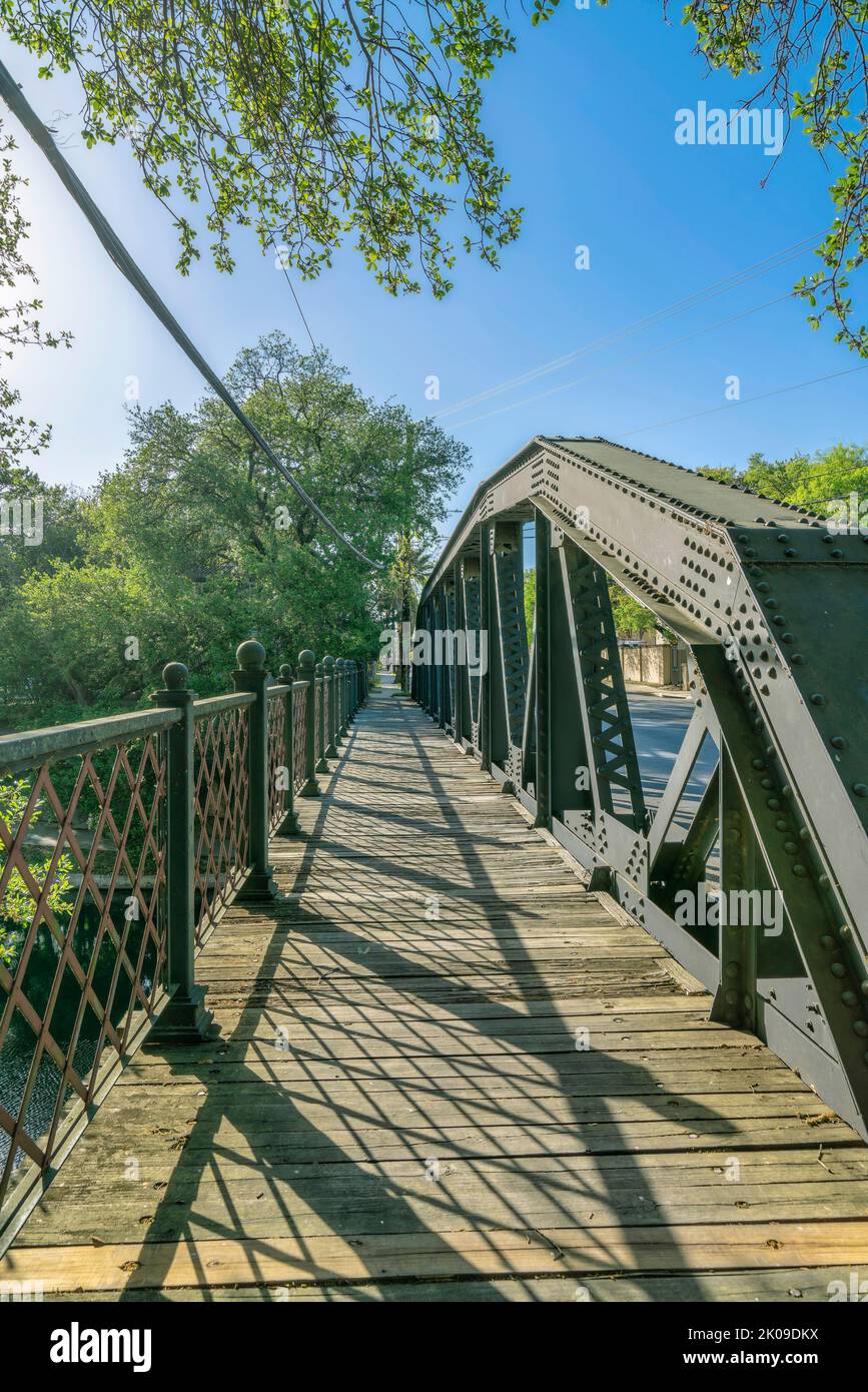 River Walk in San Antonio Texas with a bridge overlooking blue sky and ...