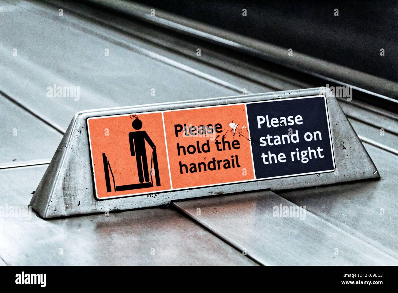 A Sign on the London Underground to stand on the right and hold the handrail. Stock Photo