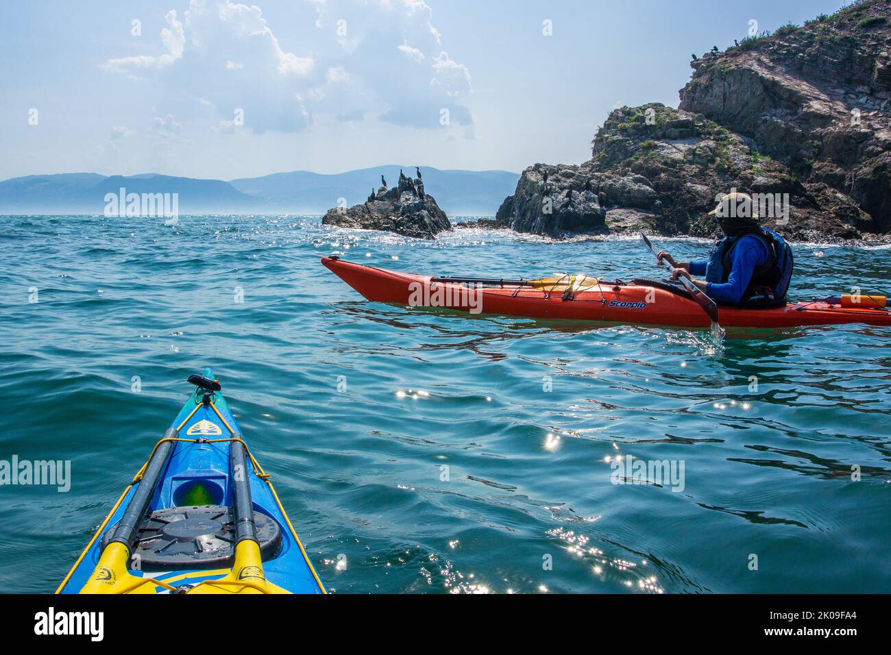 Sea kayaking near Puffin Island on the coast of Anglesey, Wales UK Stock Photo