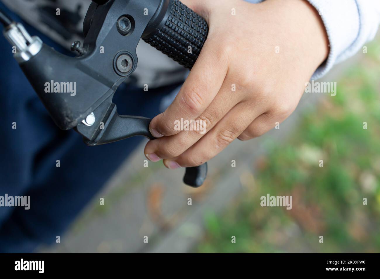 Child's hand holding the brakes on a bicycle, close up Stock Photo