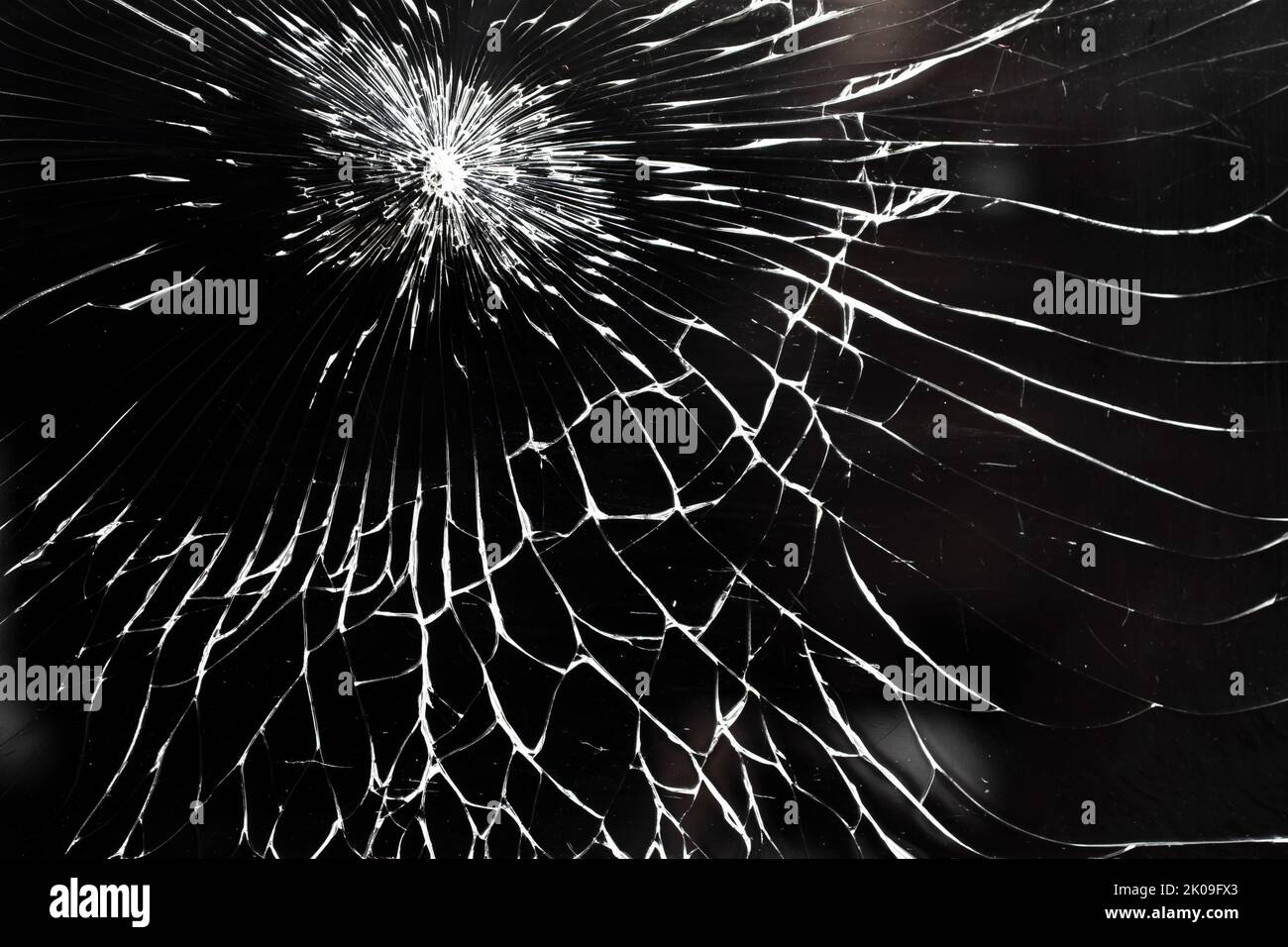 Cracked smart phone screen, abstract pattern with white lines on black background Stock Photo