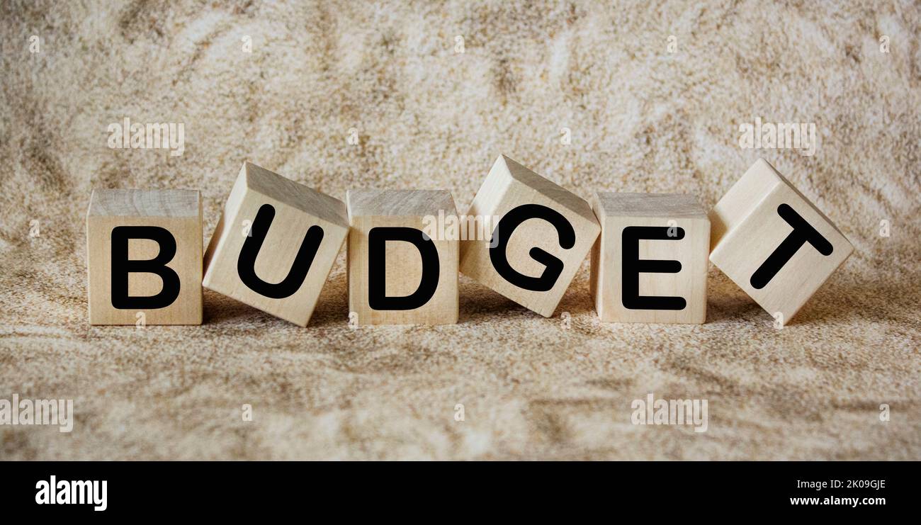 Conceptual - BUDGET word written on wooden blocks. With a vintage style background. Stock Photo