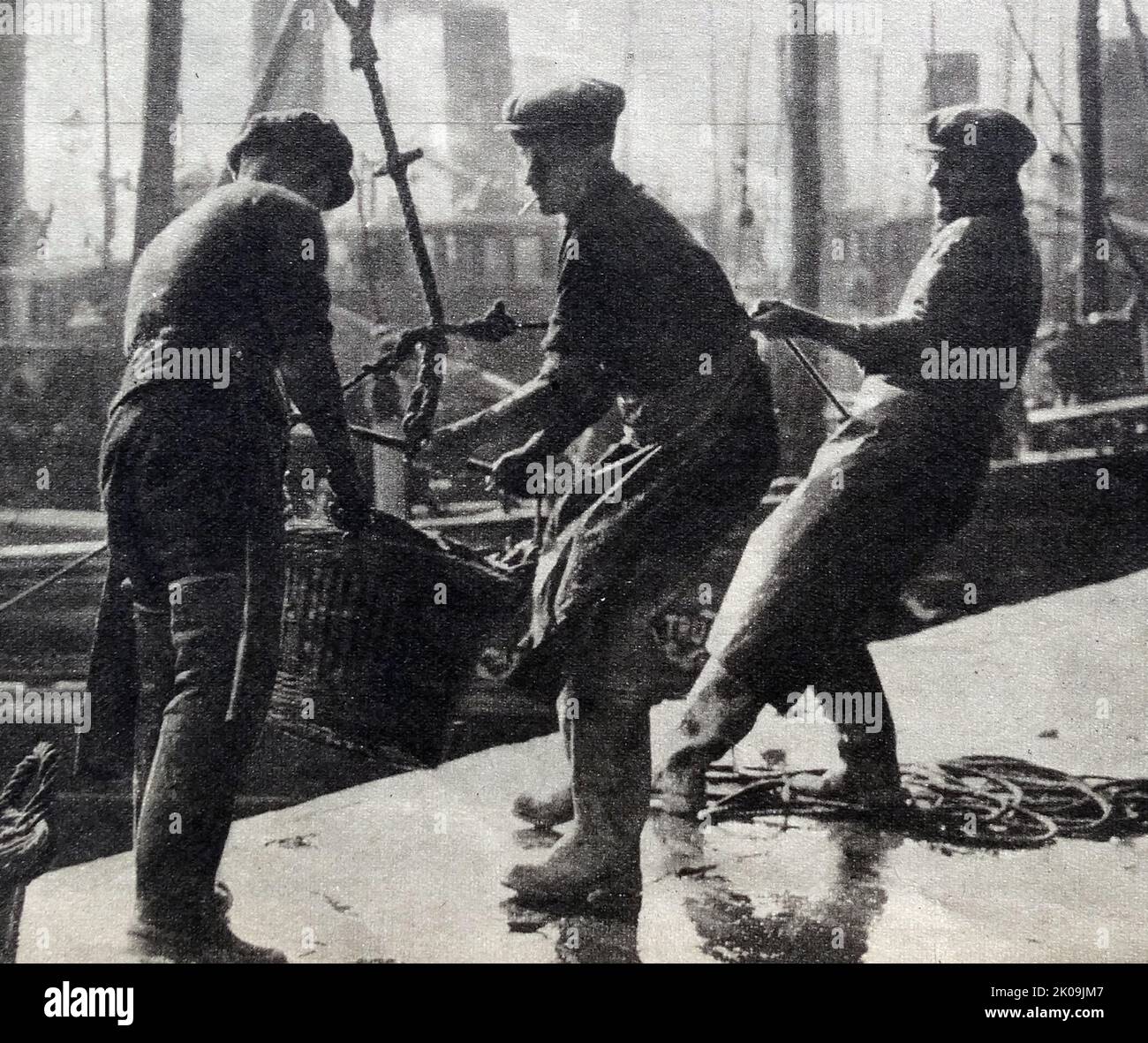English fishermen offload a catch during World War II, 1941. Stock Photo
