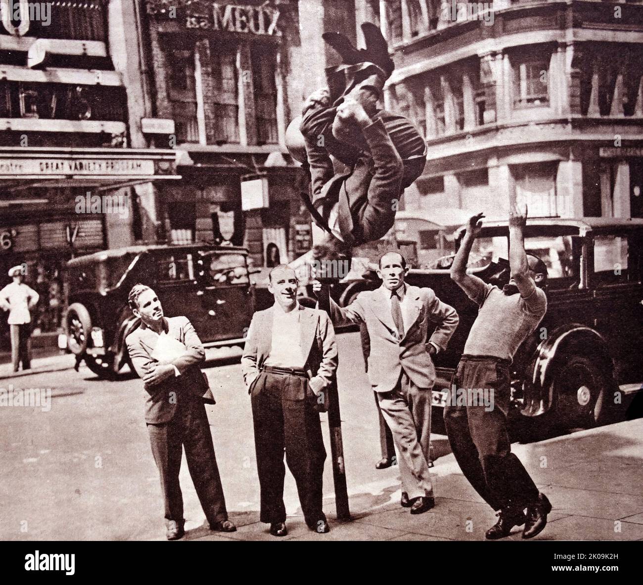 Trampolinist Johnny Lambert giving an impromtu acrobatic performance in Charing Cross Road, London. Stock Photo