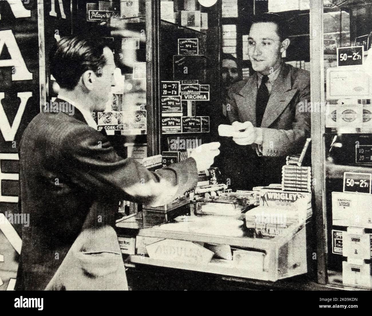 Former theatrical variety star Mick Clover in his tobacconists kiosk in the heart of Agencyland. Stock Photo