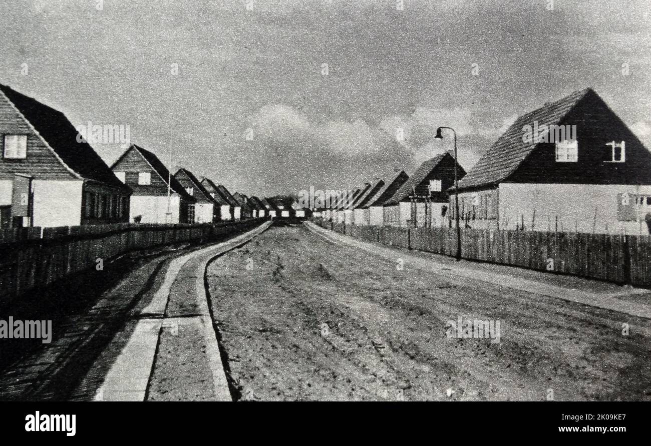 Housing for Nazi party members built at Hohen Neuendorf, a town in the Oberhavel district, in Brandenburg, Germany. It is located north west of Berlin. 1938. Nazi Germany, officially known as the German Reich from 1933 until 1943, and the Greater German Reich from 1943 to 1945, was the German state between 1933 and 1945, when Adolf Hitler and the Nazi Party controlled the country, transforming it into a dictatorship. Stock Photo