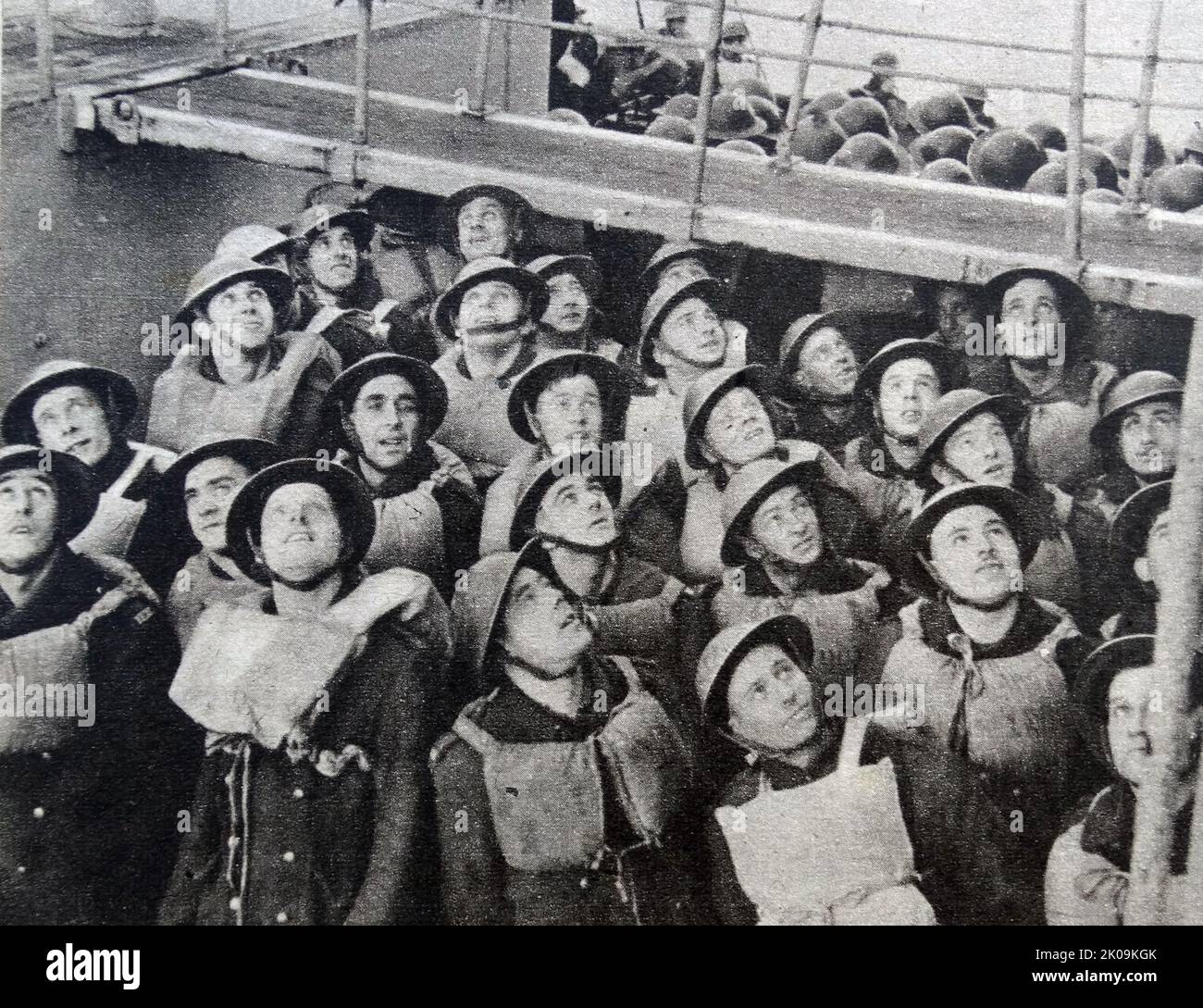 British Army troops looking out for hostile aircraft during a lifeboat drill on a troopship during World War II. Stock Photo