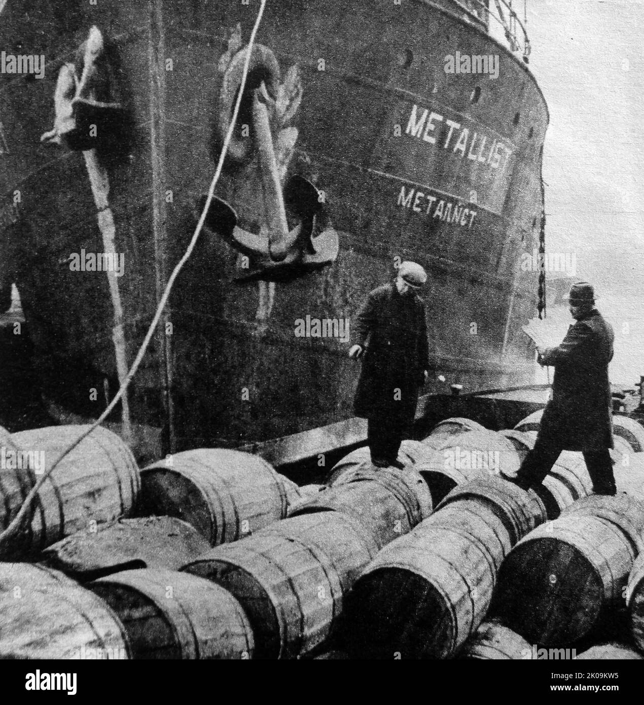 World War II: A customs officer checks on the cargo of the Nazi ship Leander. Disguised as a Russian ship and sailing under an assumed name 'Metallist', she was seized by the British Navy and brought to a British port. Stock Photo