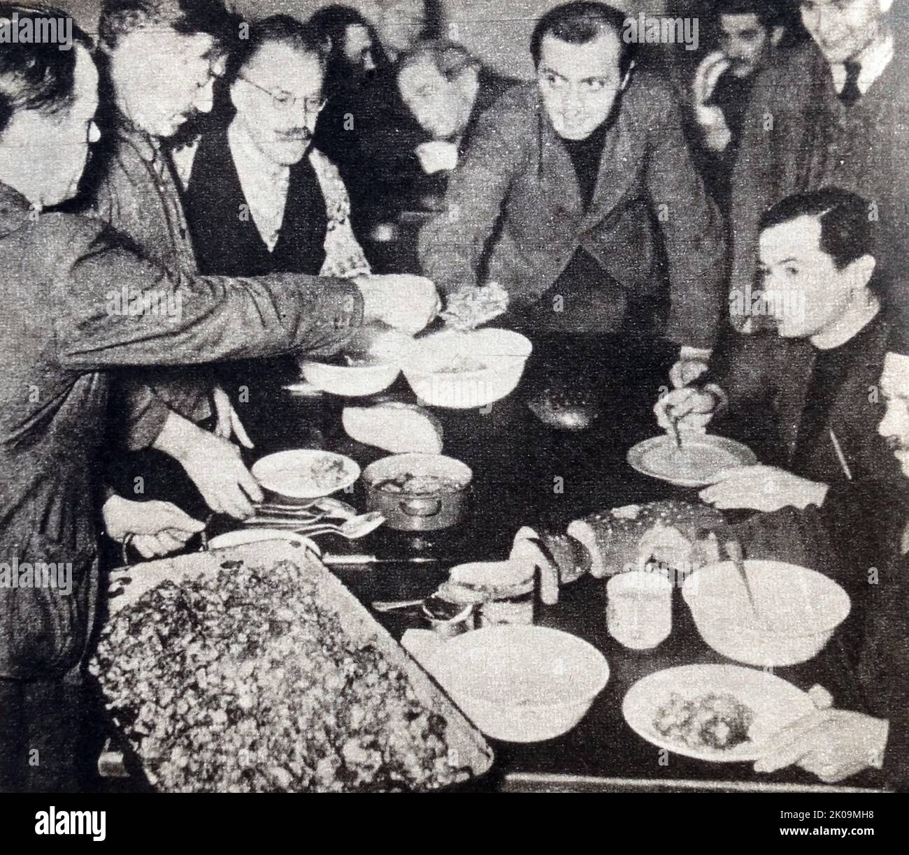 French prison orderly serves out hash for lunch at Wulzburg Castle, where the majority of prisoners are French and British, during World War II. Stock Photo