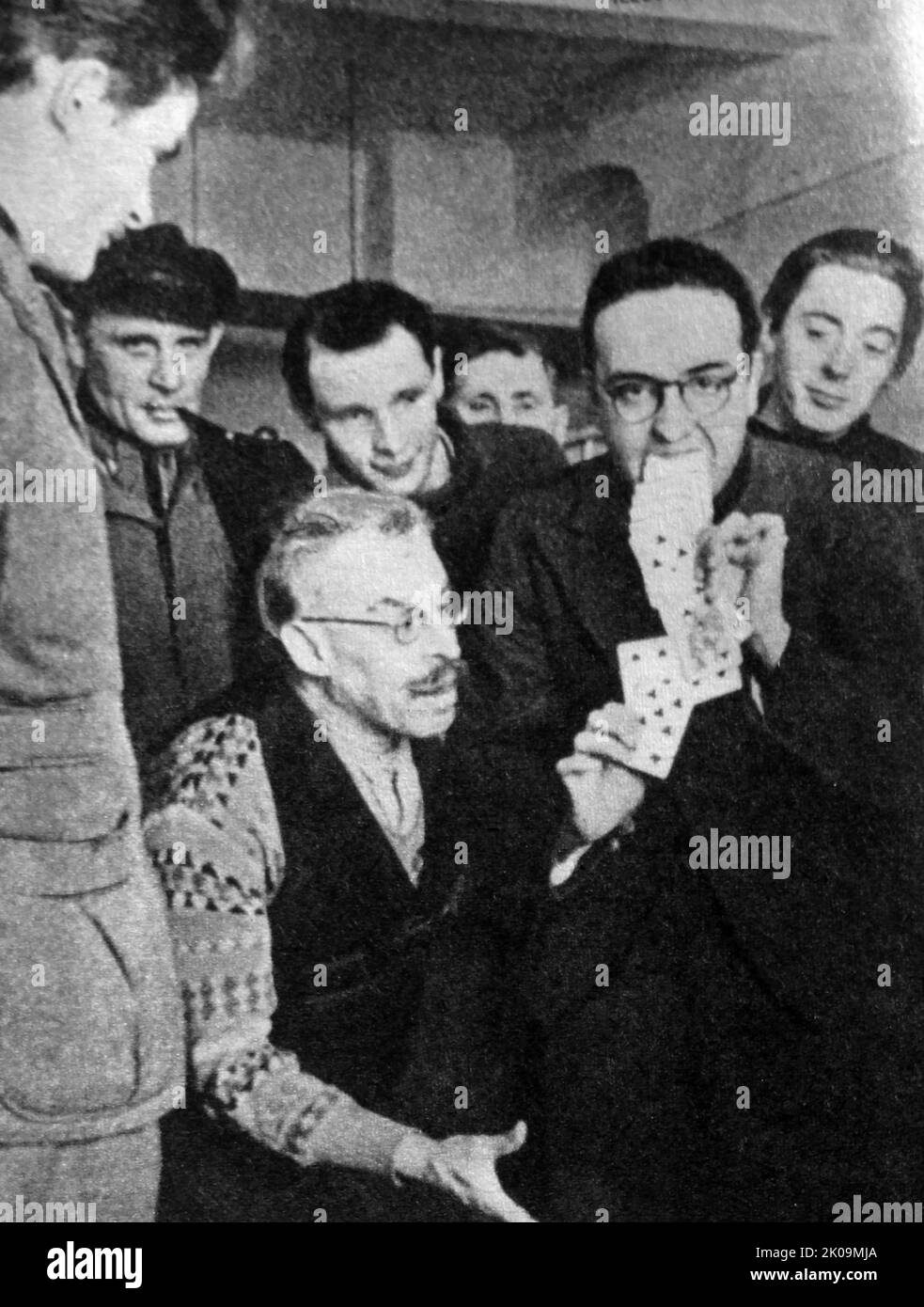 Frenchman playing card tricks in a German prisoner of war camp during World War II. Stock Photo