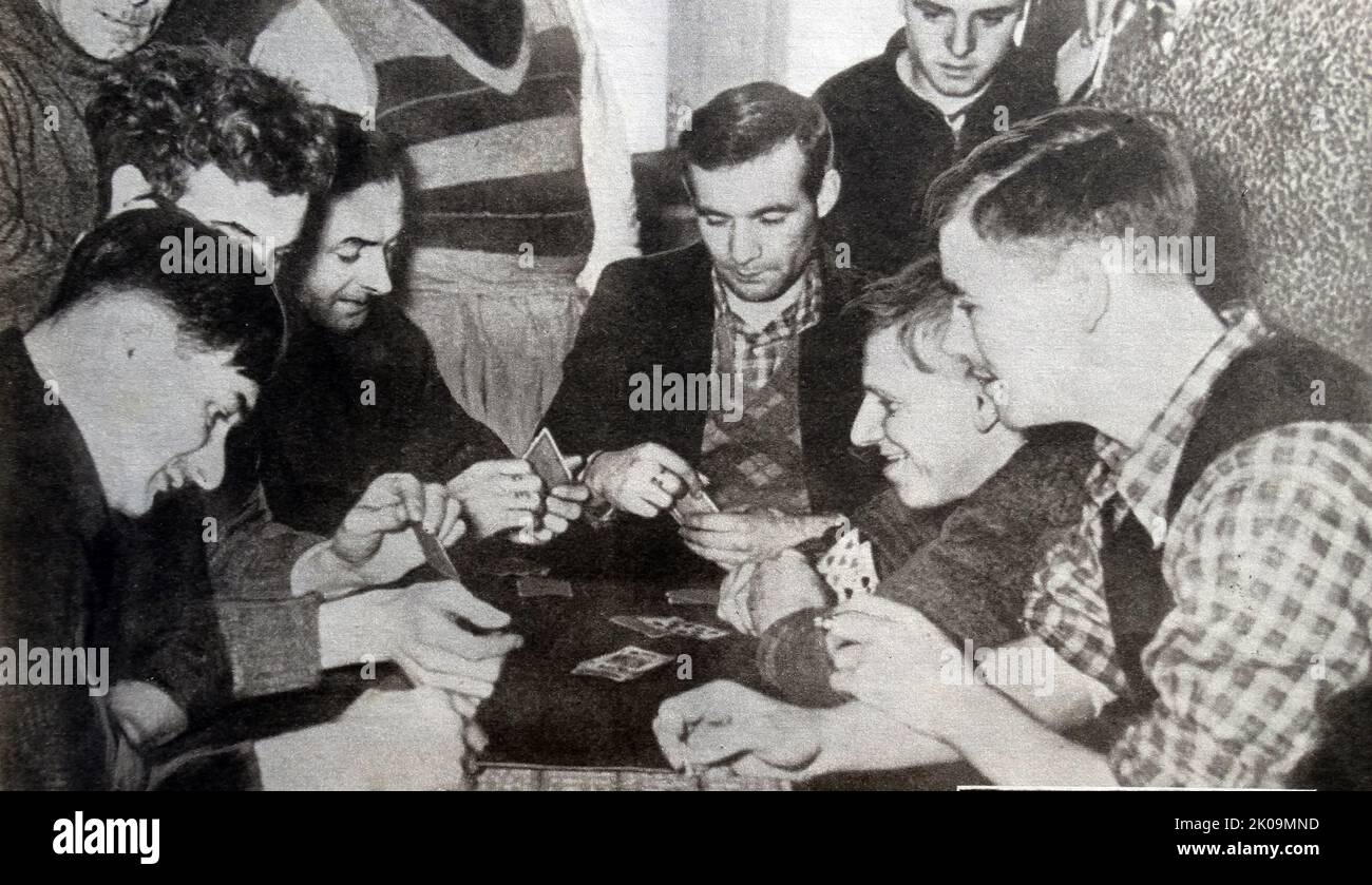 British soldiers playing cards in Wulzburg German prisoner of war camp during World War II. The Red Cross provided the games and cards. Stock Photo