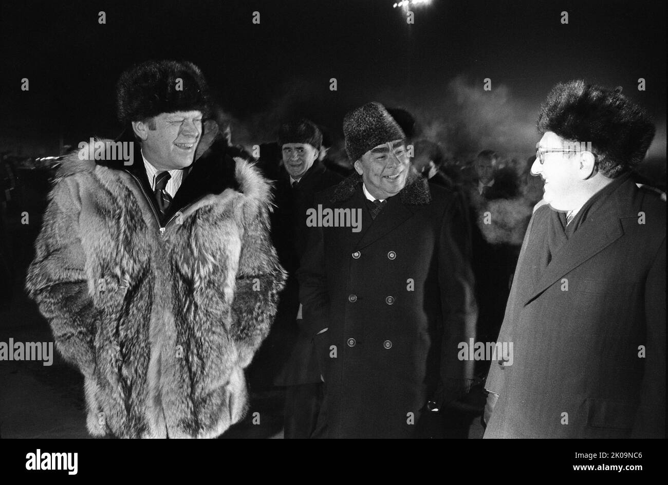 President Gerald Ford, General Secretary Lenoid Brezhnev, and Henry Kissinger speaking informally at the conclusion of the Vladivostok Summit on the tarmac at Vozdvizhenka Airport. Just moments after this photo was taken, President Ford informally concluded the Vladivostok Summit by giving his wolfskin coat to Secretary Brezhnev. 1974. Stock Photo