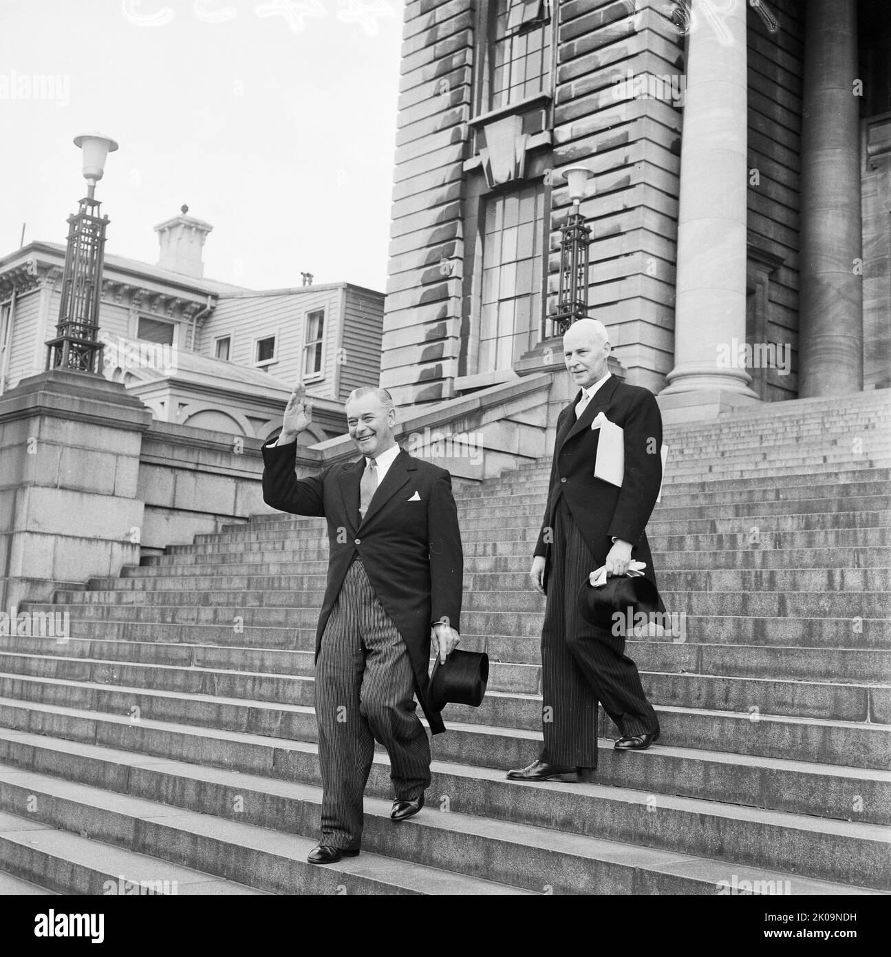 New Zealand Prime Minister-elect Keith Holyoake leaving Parliament Buildings with the Clerk of the Executive Council, on the way to Government House. Photographed on 12 December 1960 by an Evening Post staff photographer. Stock Photo