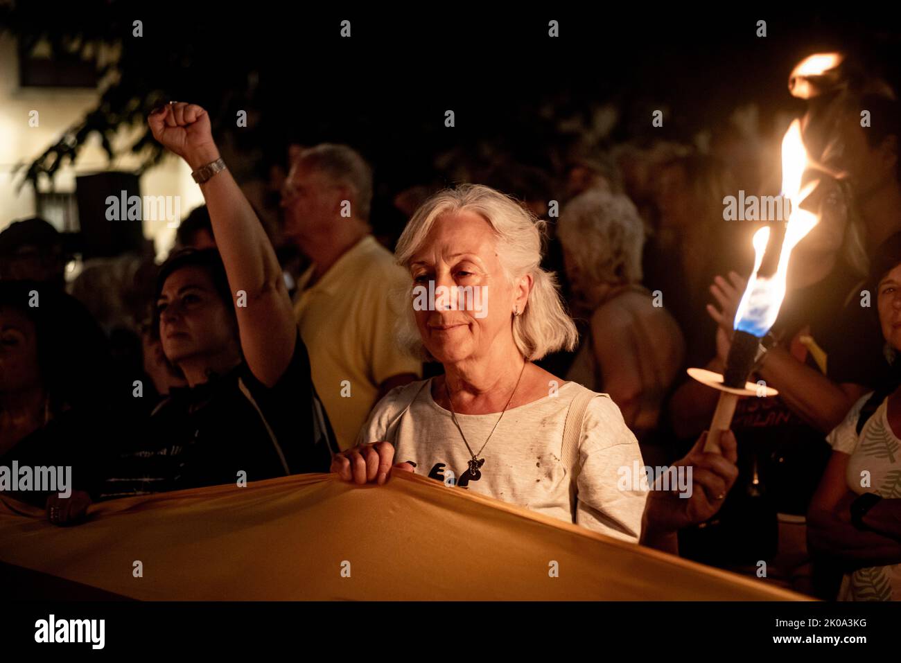 Sept. 10, 2022. Barcelona, Catalonia, Spain: A woman holds a torche as pro-independence supporters  gather at El Fossar de les Moreres (historical and symbolic place of the Catalan celebrations in Barcelona) the night before of the Catalonia National Day (La Diada). Credit: Jordi Boixareu/Alamy Live News Stock Photo