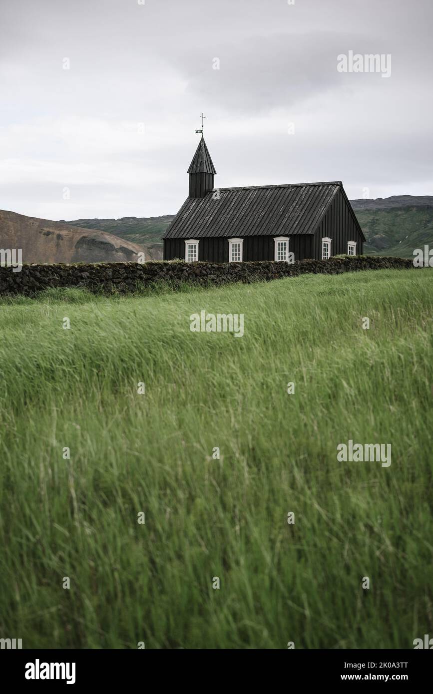 Landscape with black wooden church Budakirkja near the village Budhir in Iceland Stock Photo
