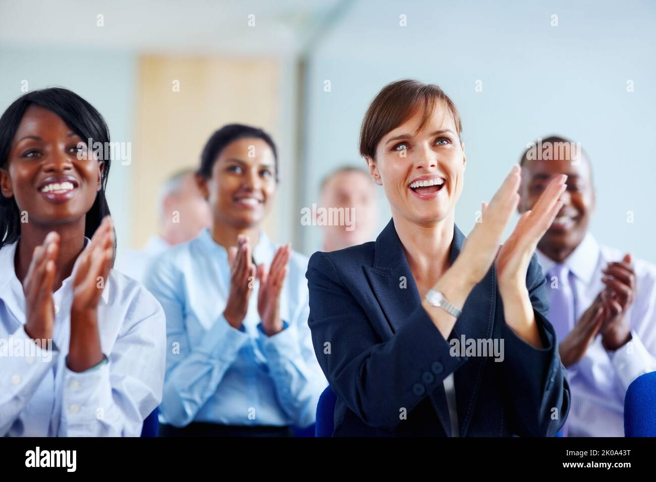 Group of colleagues applauding. View of group of executives applauding. Stock Photo