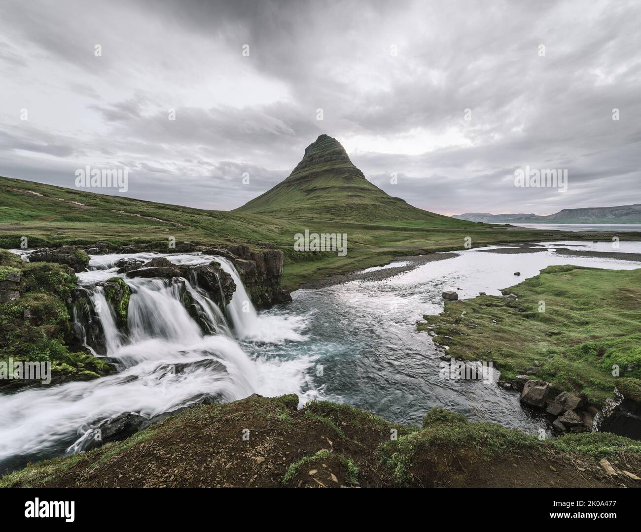 Kirkjufellsfoss waterfall and Kirkjufell mountain near the city of Grundarfjordur in Iceland Stock Photo