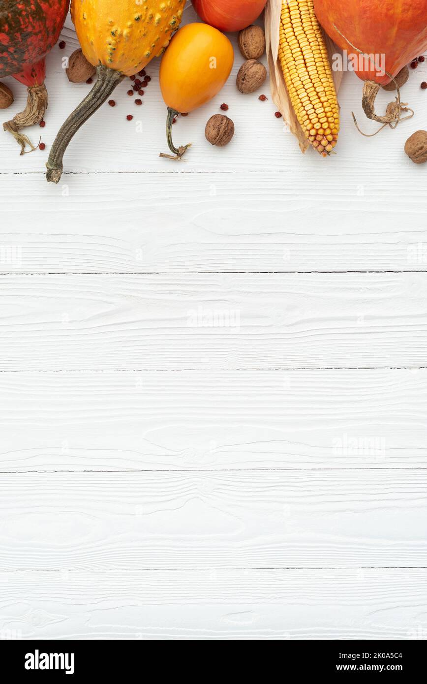 Autumn background with decoration from pumpkin on white background. Flat lay, top view, copy space Stock Photo