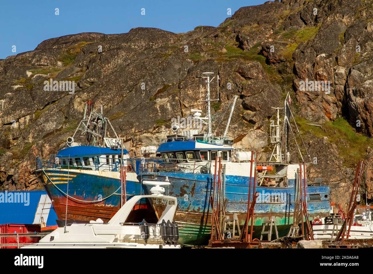 Old fishing boats in harbor at Ilulissat , Greenland. , a Unesco World Heritage Site. Stock Photo
