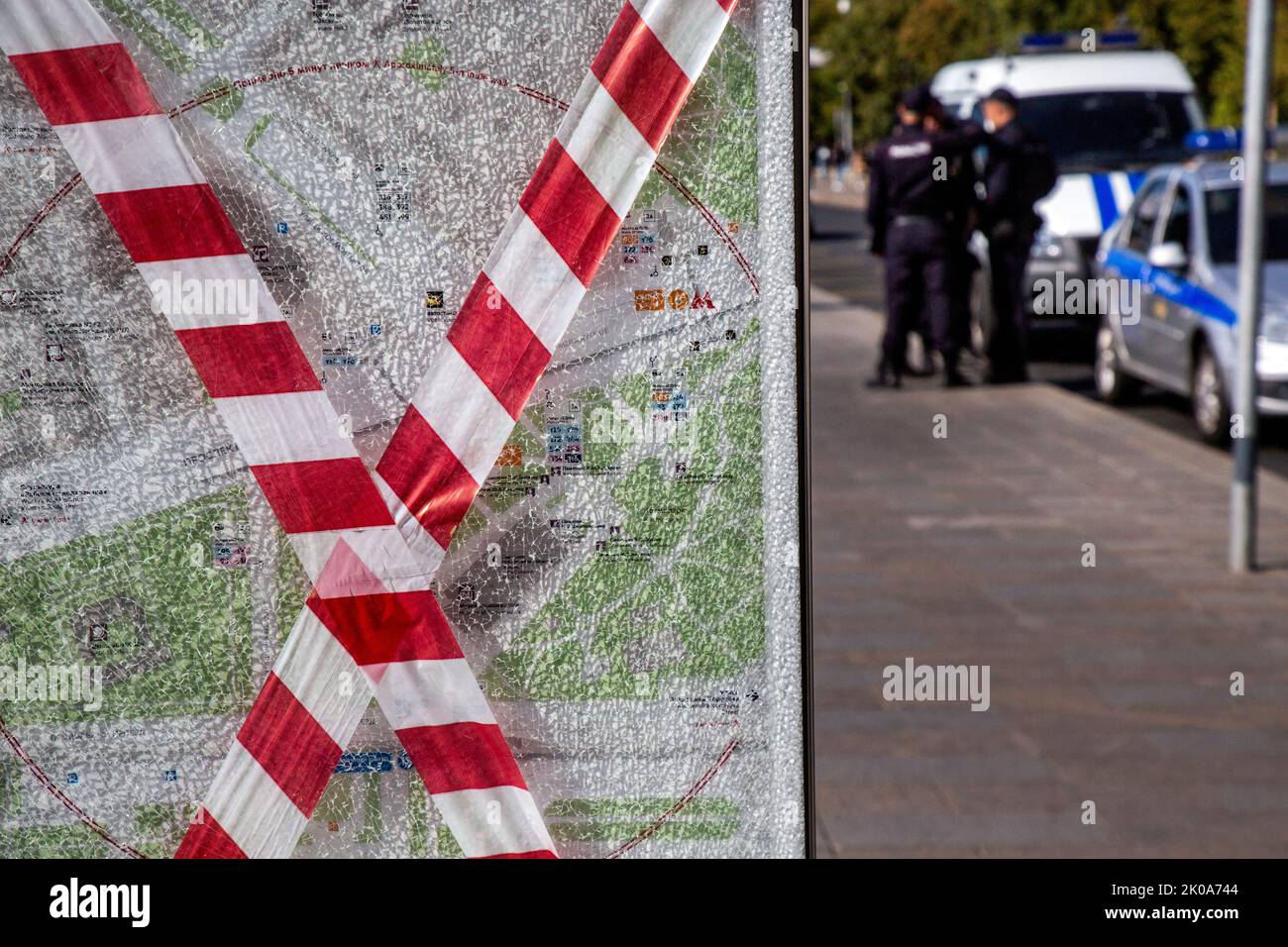 A broken glass showcase with a city map on the background of a police outfit in Moscow , Russia Stock Photo