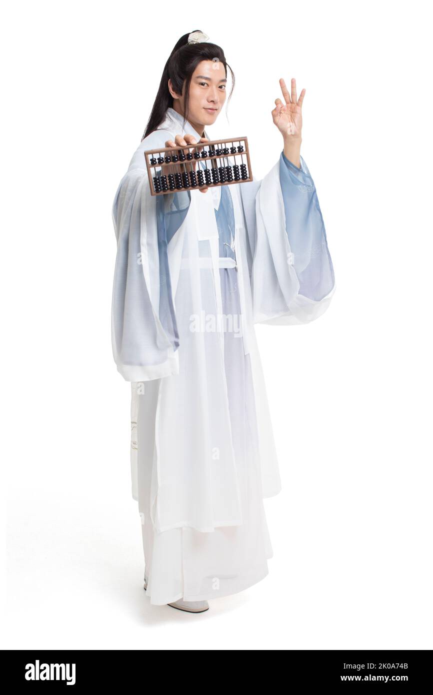 Young Chinese man in ancient costume holding an abacus Stock Photo