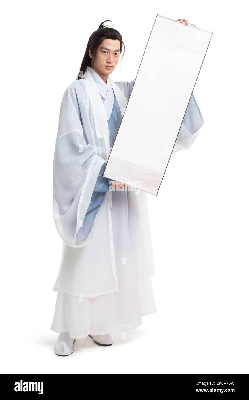Young Chinese man in ancient costume holding a blank scroll Stock Photo