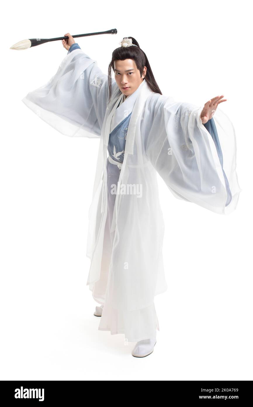 Young Chinese man in ancient costume writing calligraphy Stock Photo