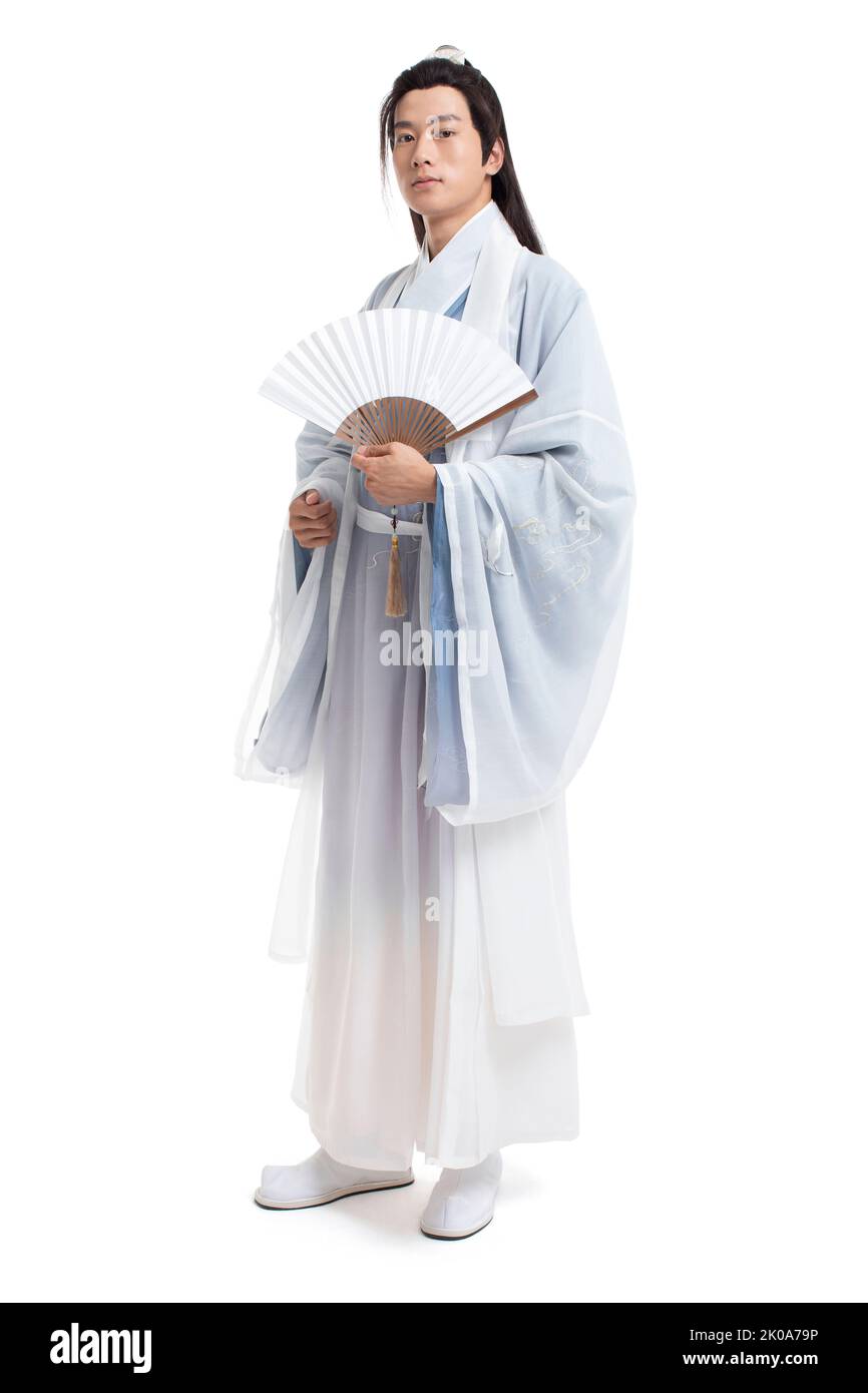 Young Chinese man in ancient costume holding a fan Stock Photo