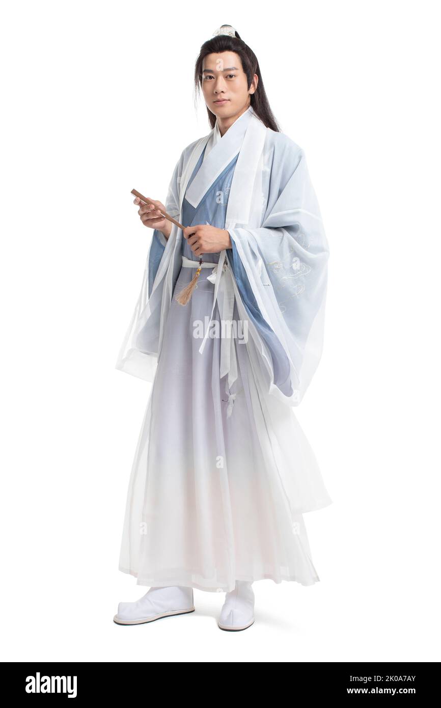 Young Chinese man in ancient costume holding a fan Stock Photo