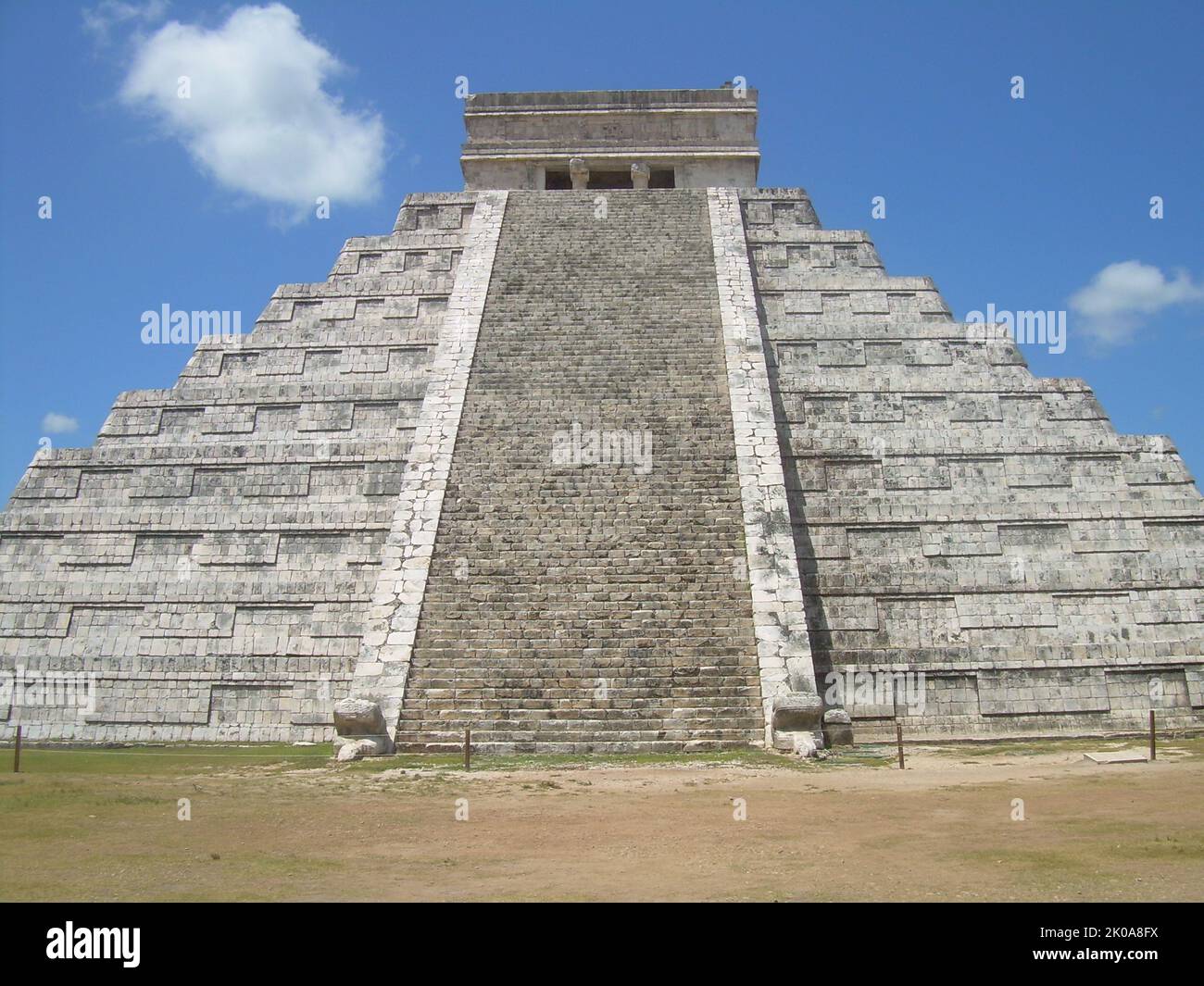 La Piramide, known as the Temple of Kukulca, a Mesoamerican step-pyramid that dominates the centre of the Chichen Itza archaeological site in the Mexican state of Yucatan. The pyramid building is more formally designated by archaeologists as Chichen Itza Structure 5B18. Built by the pre-Columbian Maya civilization between the 8th and 12th centuries AD, the pyramid served as a temple to the deity Kukulcan, the Yucatec Maya Feathered Serpent deity closely related to Quetzalcoatl Stock Photo
