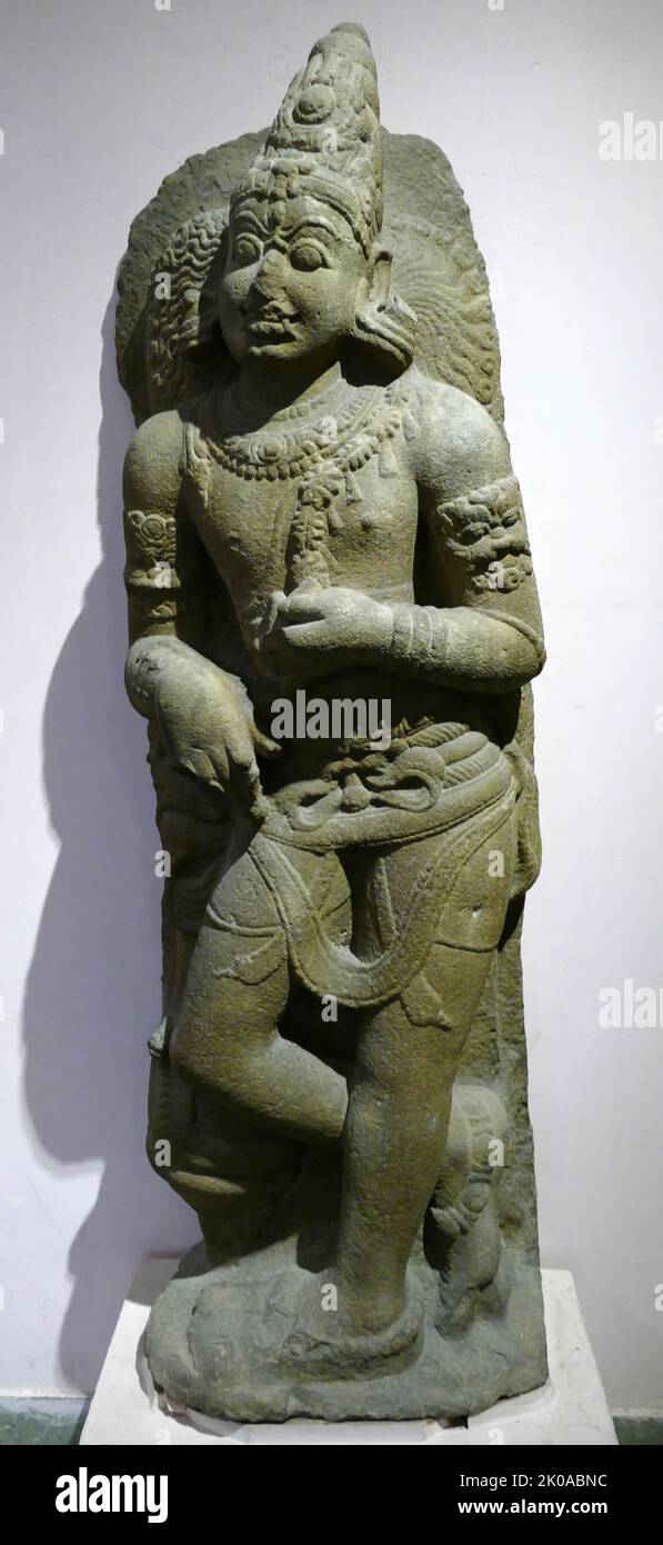 Dvarapala. Early Chola, 10th century AD. South India. Stone. A Dvarapala or Dvarapalaka is a door or gate guardian often portrayed as a warrior or fearsome giant. The dvarapala statue is a widespread architectural element throughout Hindu, Buddhist and Jaina cultures Stock Photo