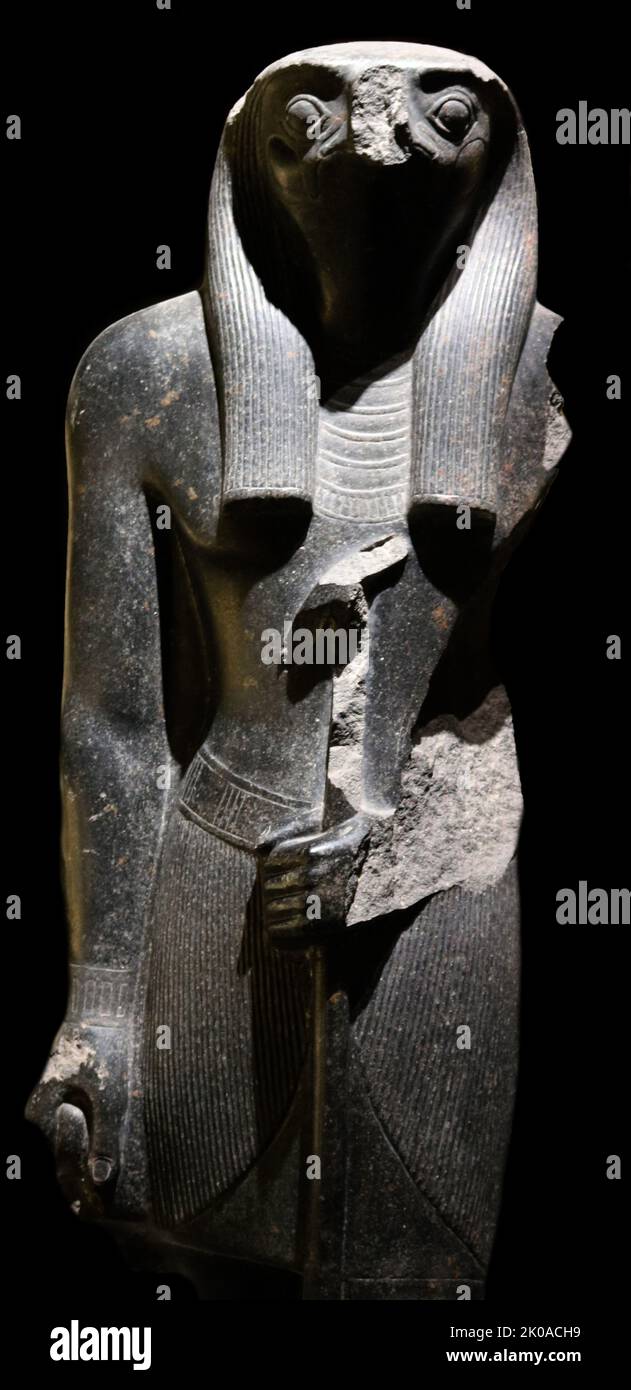 Granite statue of Horus, Ancient Egyptian, deity who served many functions, most notably god of kingship and the sky. He was worshipped from at least the late prehistoric Egypt until the Ptolemaic Kingdom and Roman Egypt. 1570 - 1070 BC New Kingdom Stock Photo
