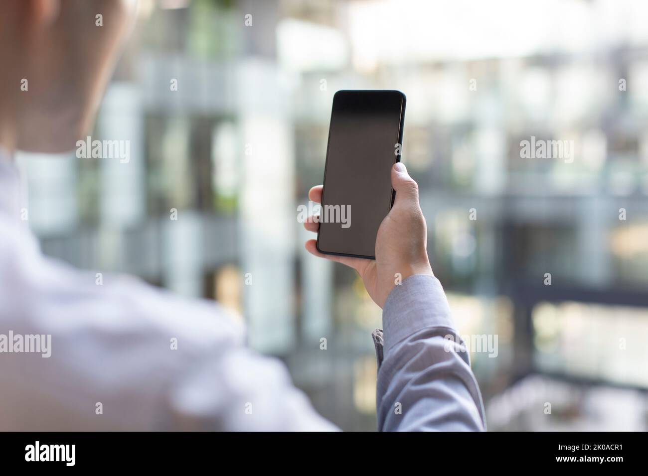 Young Chinese businessman using smart phone Stock Photo