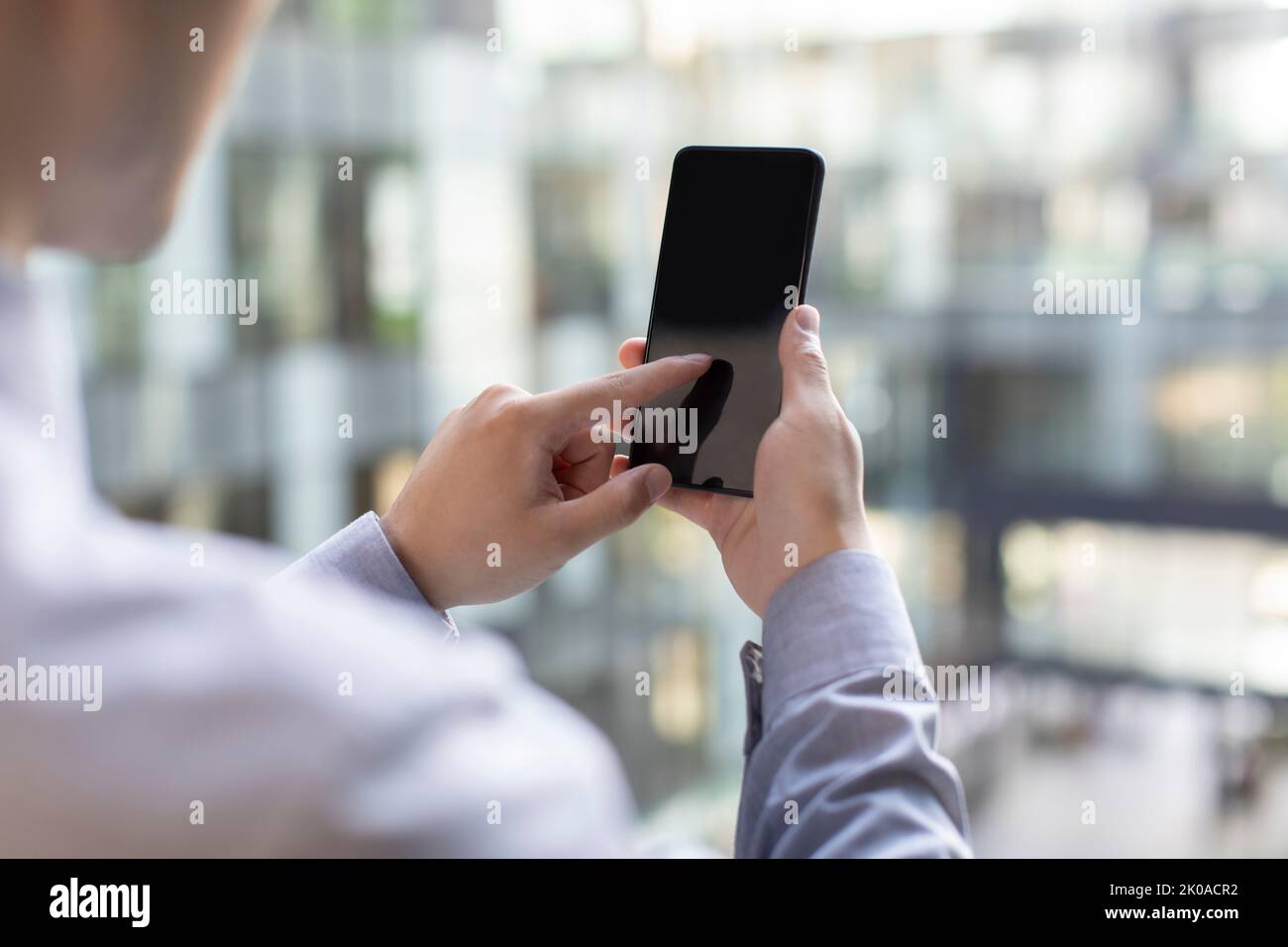 Young Chinese businessman using smart phone Stock Photo