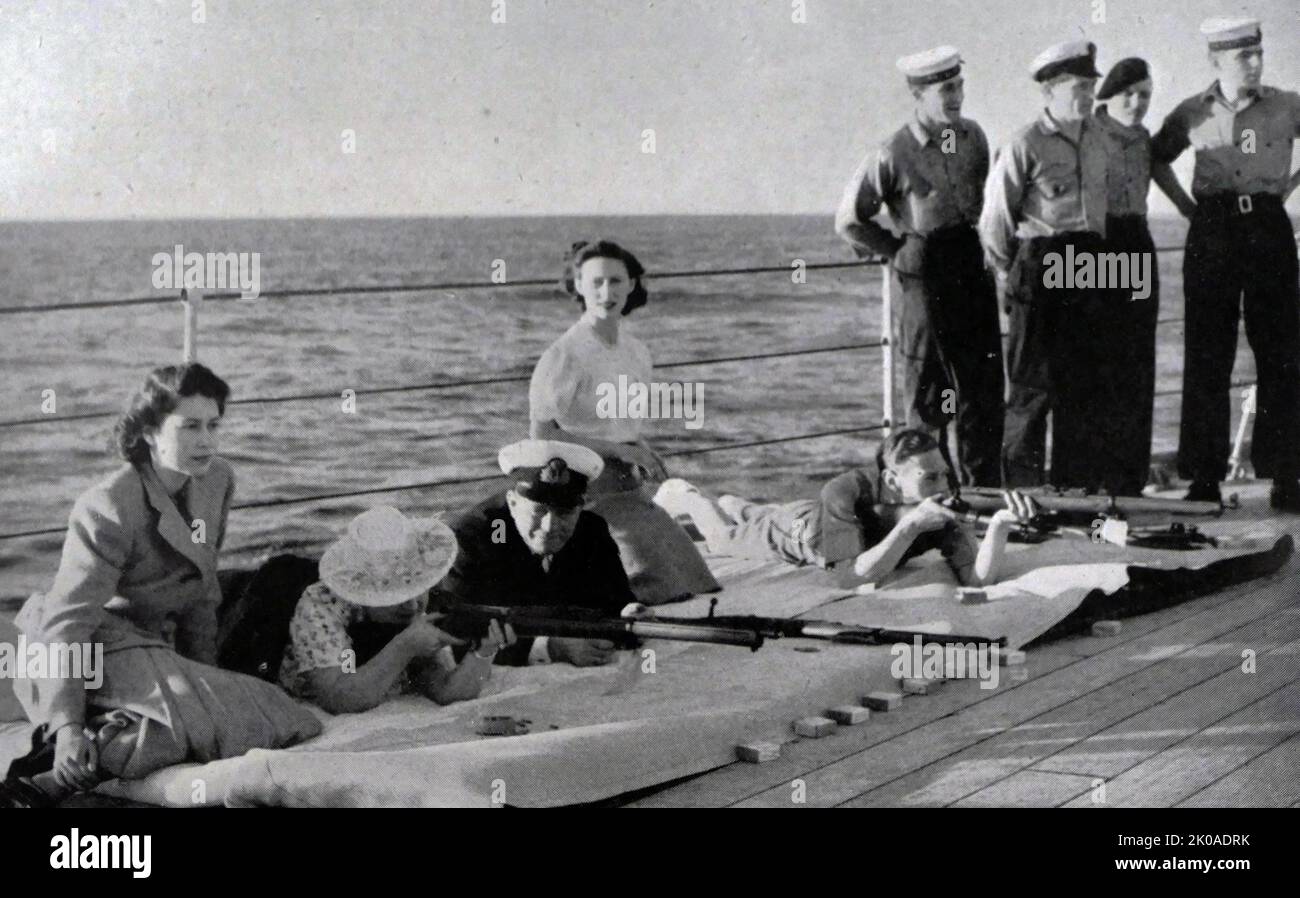 King George VI of England with Queen Elizabeth, Princess Margaret and Princess Elizabeth (later Queen Elizabeth II), aboard HMS Vanguard en-route to South Africa, 1947 Stock Photo