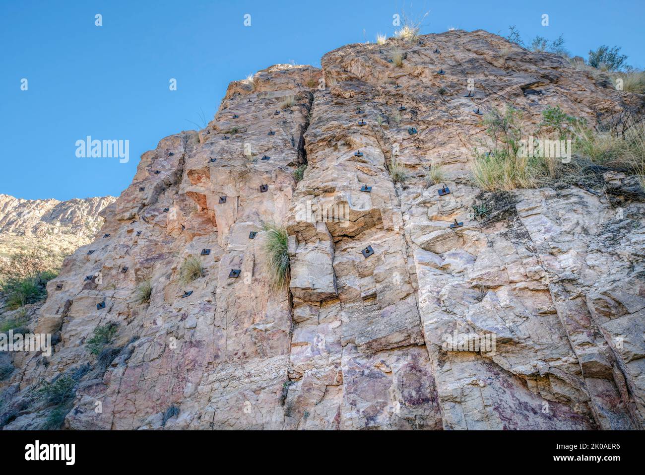 Rocky mountain cliff with rock climbing anchor bolts at Sabino Canyon