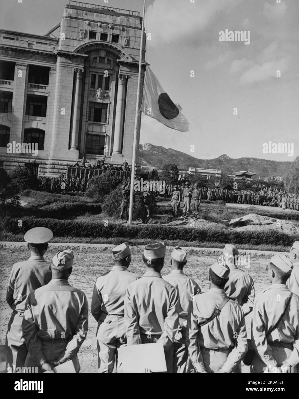 Surrender of Japanese Forces in Southern Korea, September 1945. Description: Lowering the Japanese flag, during surrender ceremonies at Seoul, Korea, 9 September 1945. Stock Photo