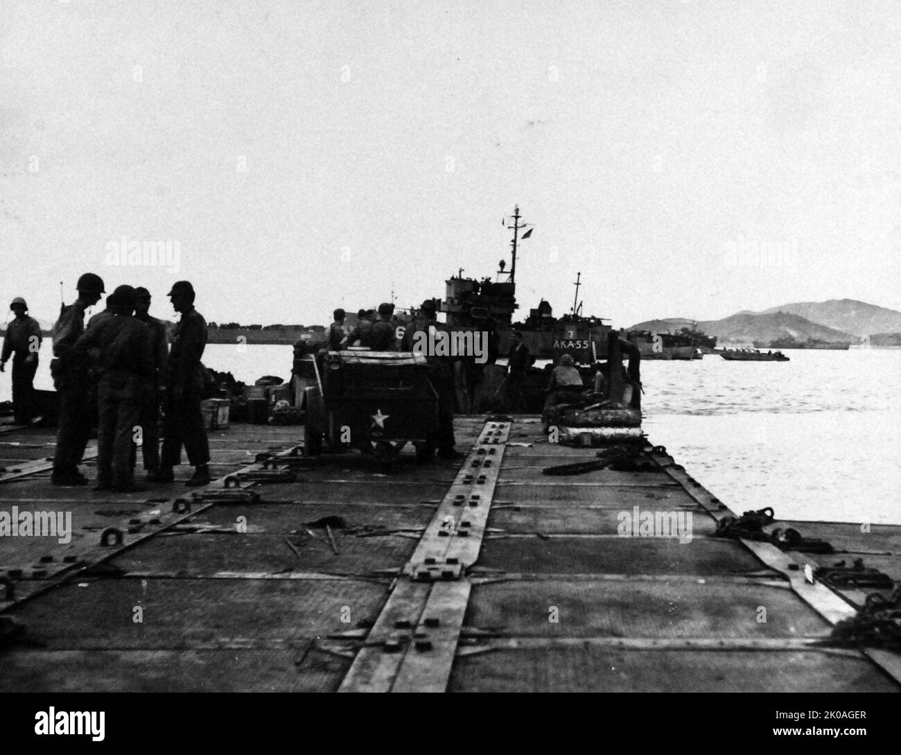 Korean War: Inchon Invasion, September 1950. U.S. Navy Seabees unload equipment from USS Alshain (AKA-55) at pontoon pier at Wolmi Do Island, Korea, September 17, 1950. Stock Photo