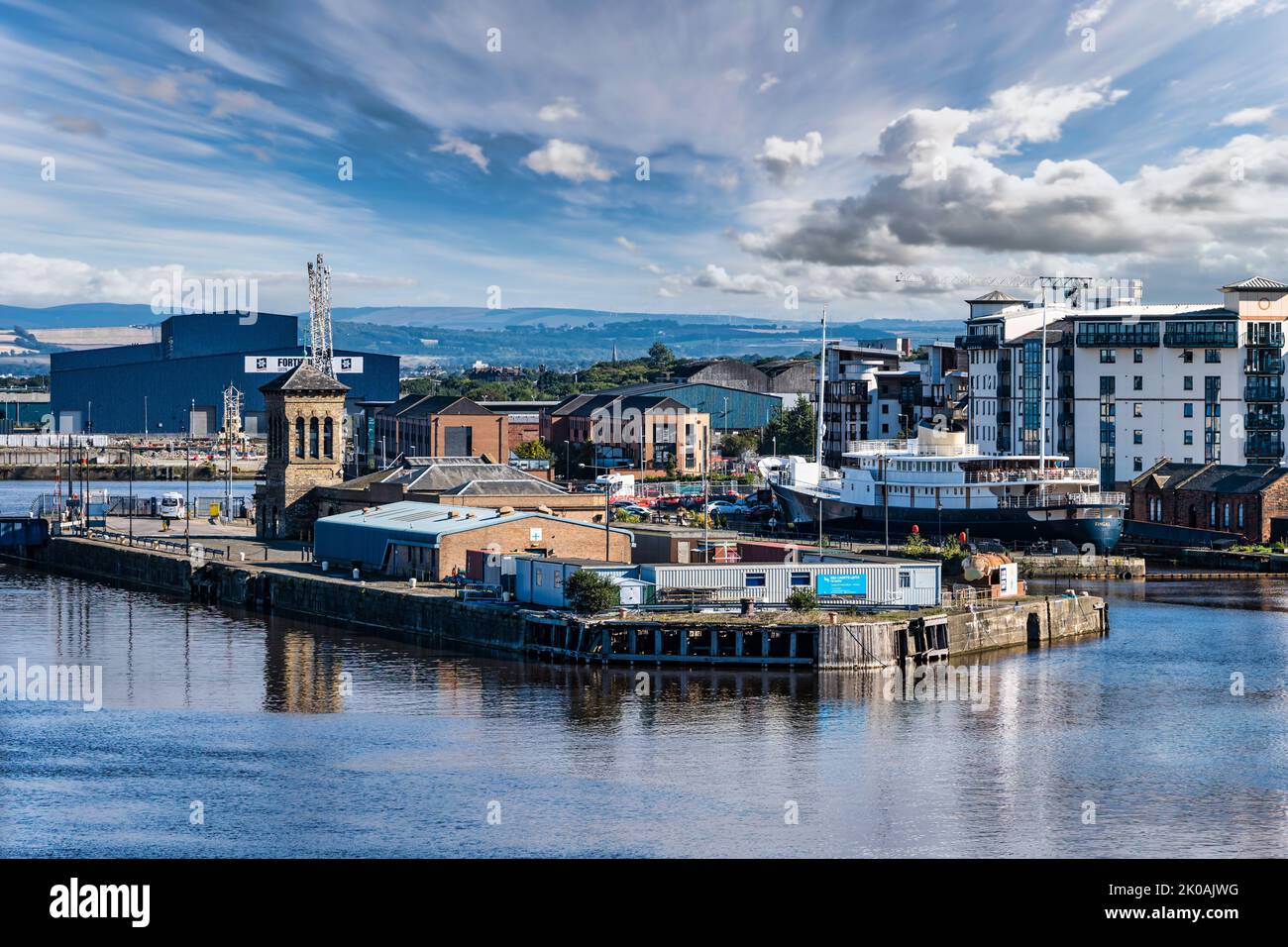 View over Leith Harbour dockland with Forth Ports Big Blue Shed & Fingal floating hotel ship, Edinburgh, Scotland, UK Stock Photo