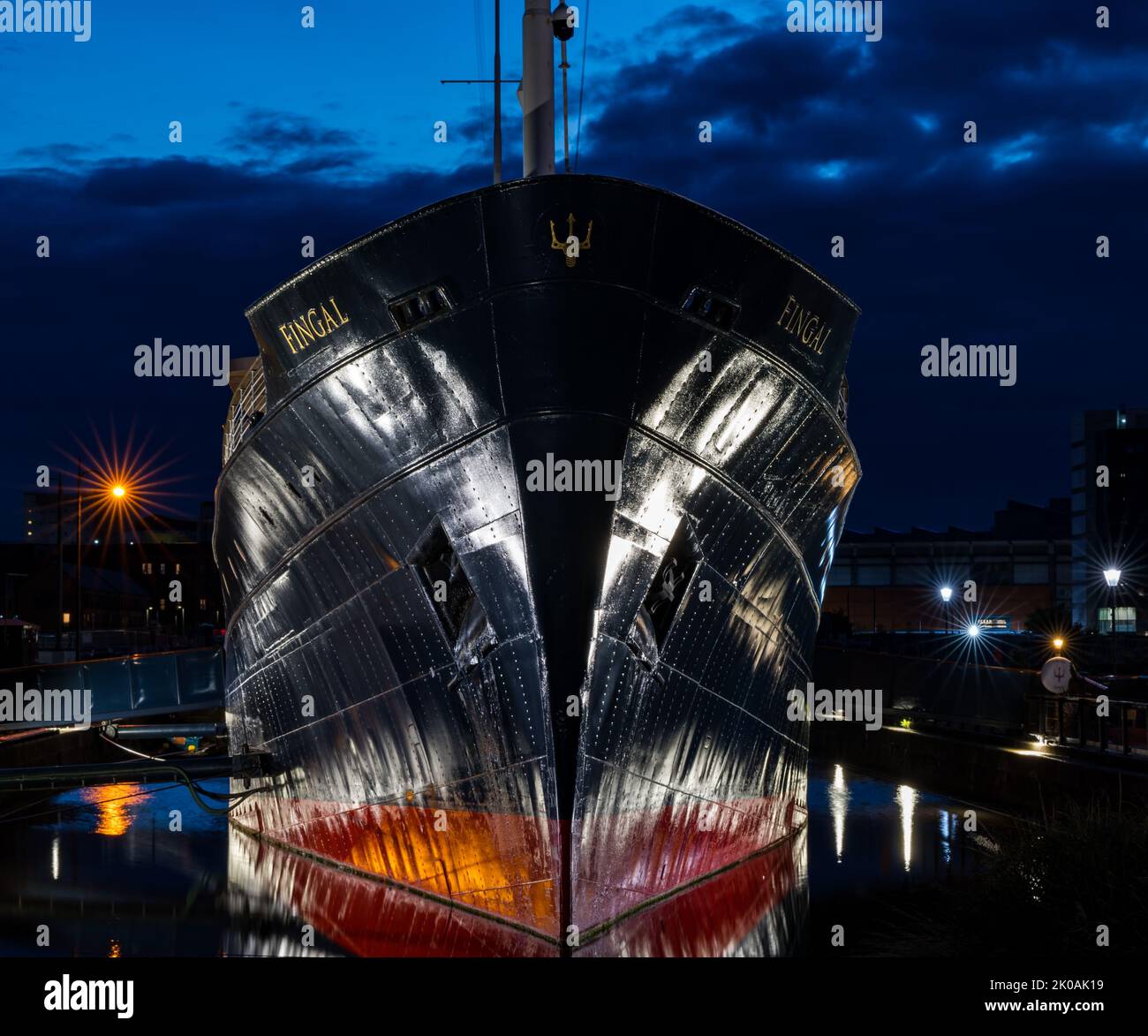 Bow of luxury floating hotel ship Fingal Edinburgh lit up at night in dock, Leith Harbour, Scotland, UK Stock Photo