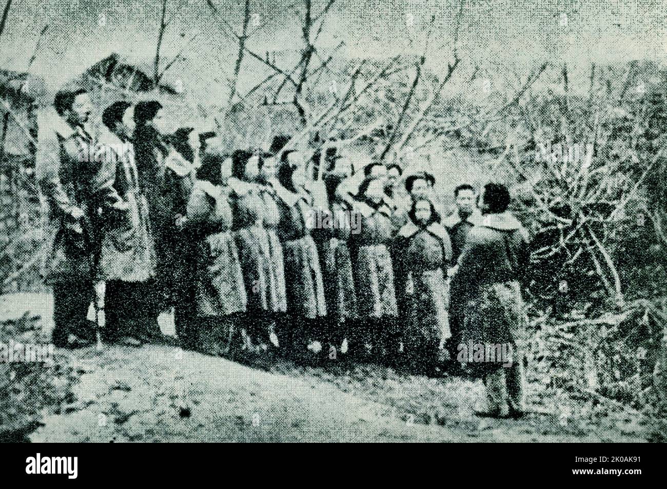 Girl scout Yang Huimin contributes the national flag, encouraging sentiments against Japan's invasion. This was during the Japanese invasion of China. Stock Photo